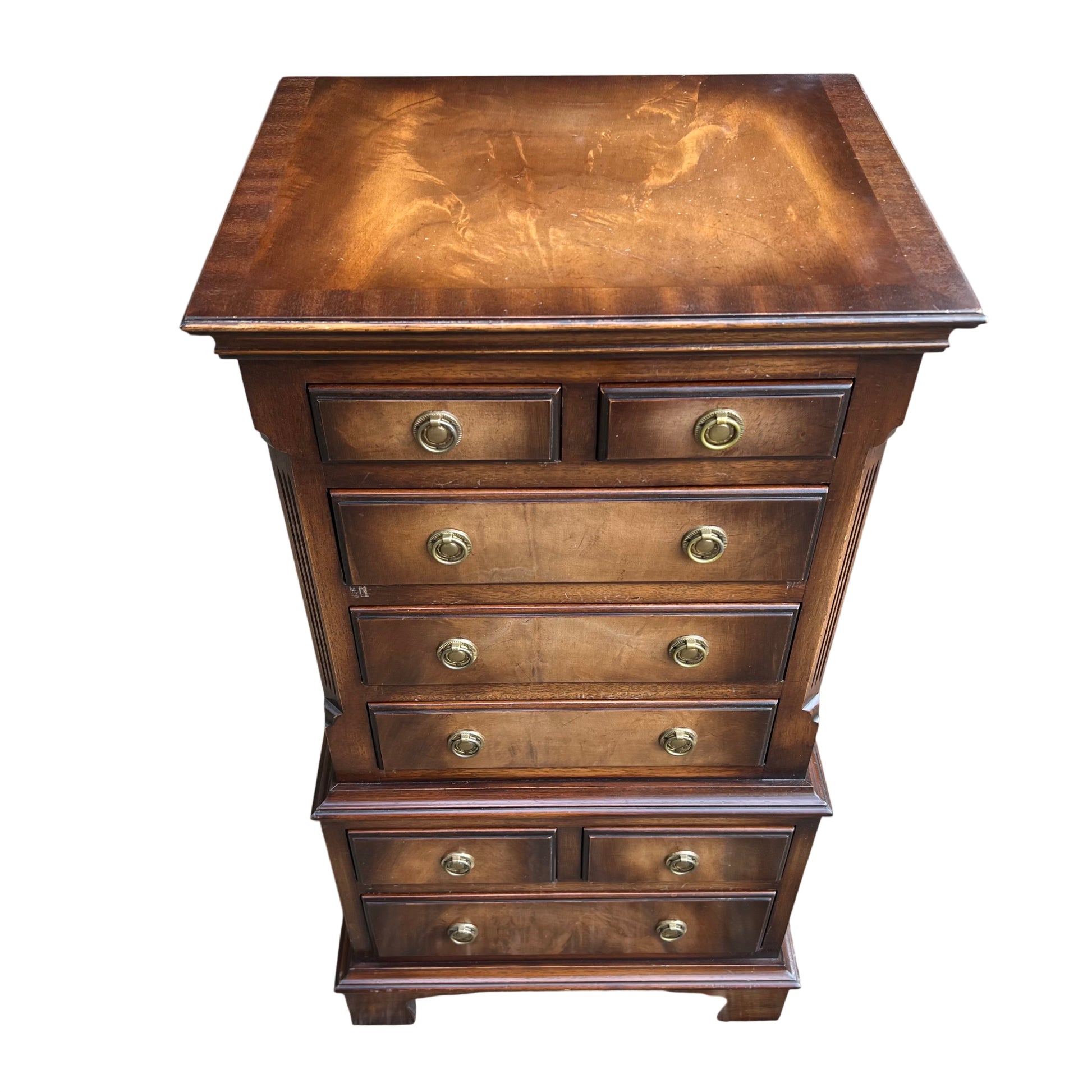 Front view of a narrow vintage tallboy chest of drawers with two small top drawers and larger lower drawers