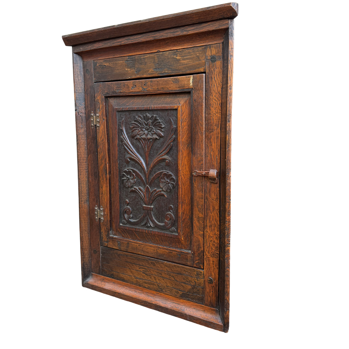 Arts & Crafts oak corner wall cabinet with carved floral panel and original latch