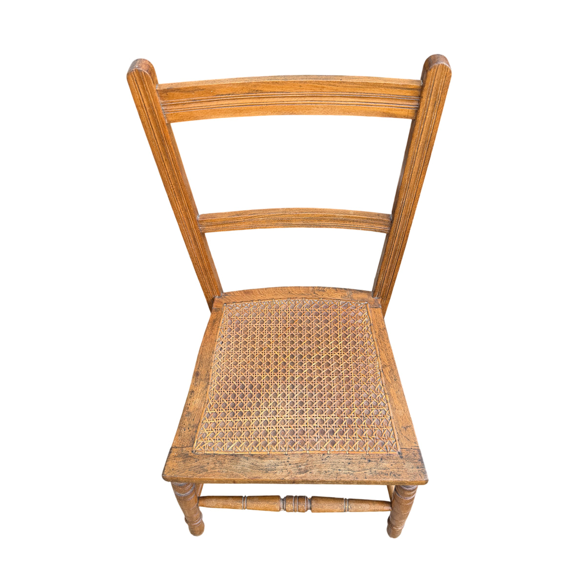 Close-up of woven cane seat on vintage wooden dining chair
