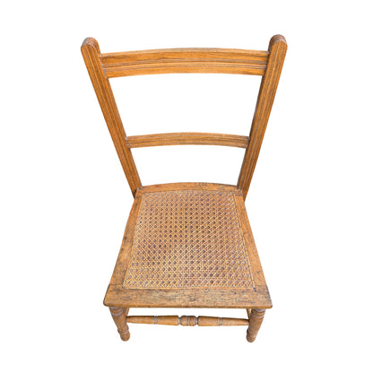 Close-up of woven cane seat on vintage wooden dining chair