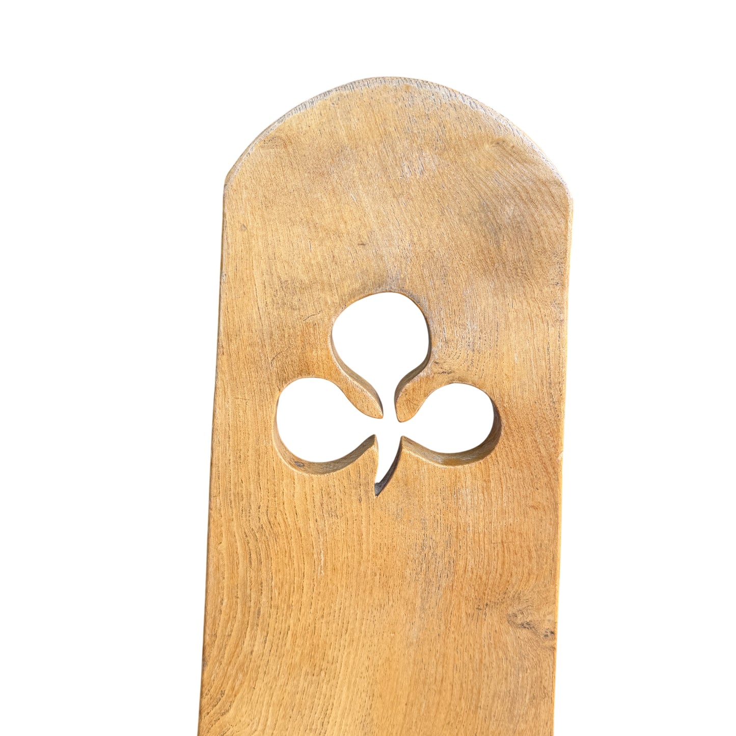 Close-up of carved club cut-out on oak chair backrest