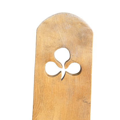 Close-up of carved club cut-out on oak chair backrest