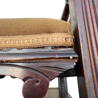 Drawer front with missing pull and decorative brass escutcheon on stool