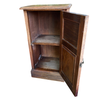 Original metal drop handle and escutcheon on a vintage bedside cabinet