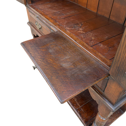 Right-side view of vintage oak cabinet on stand showing moulded top edge