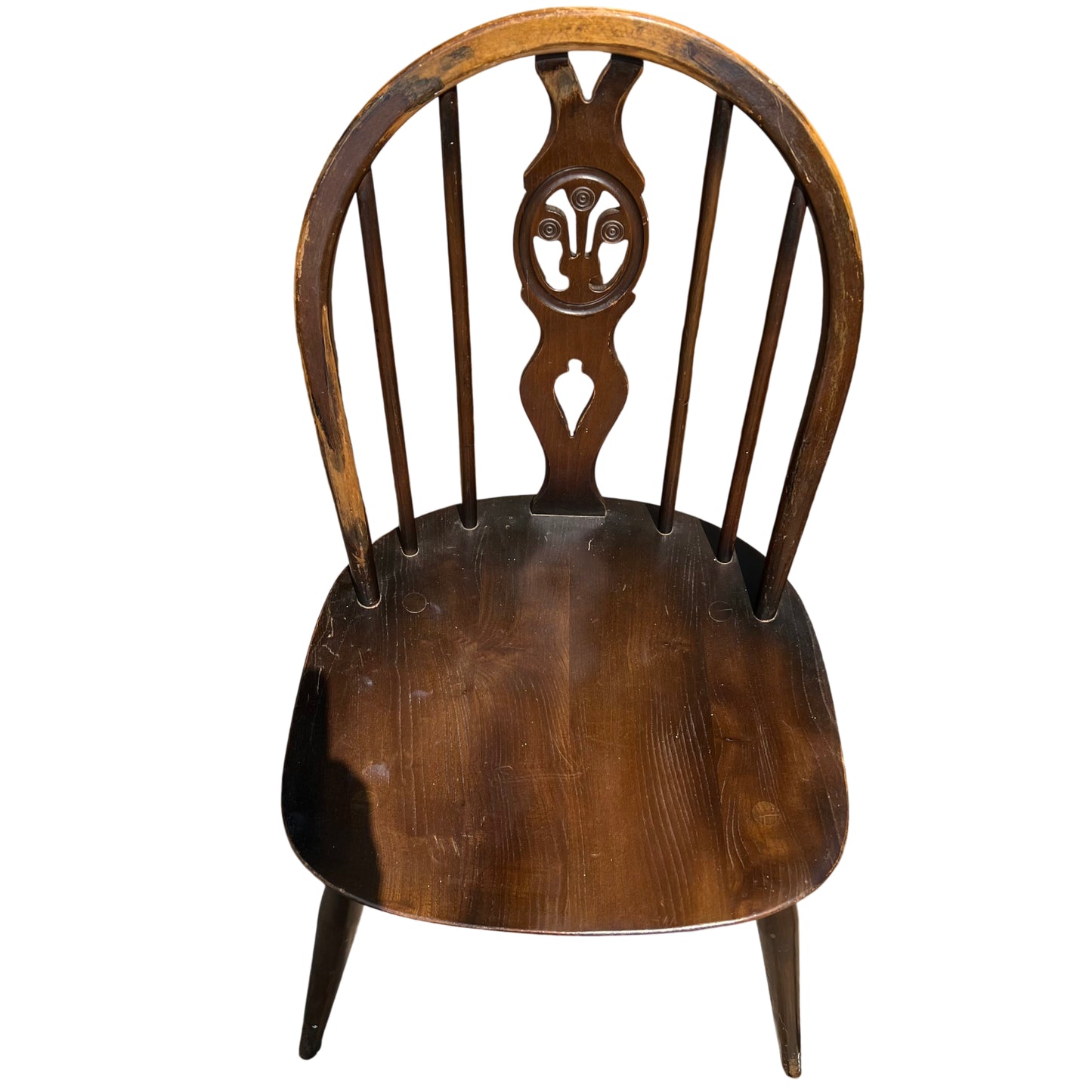 Close-up of wooden chair seat showing grain and circular dowel plugs