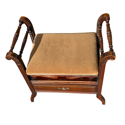 Side view showing scrolled arm, turned spindle supports and cabriole style leg