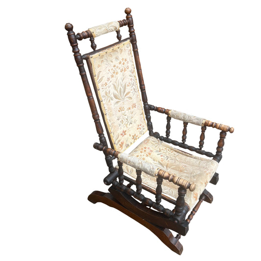 Victorian turned spindle rocking armchair with floral tapestry upholstery front view