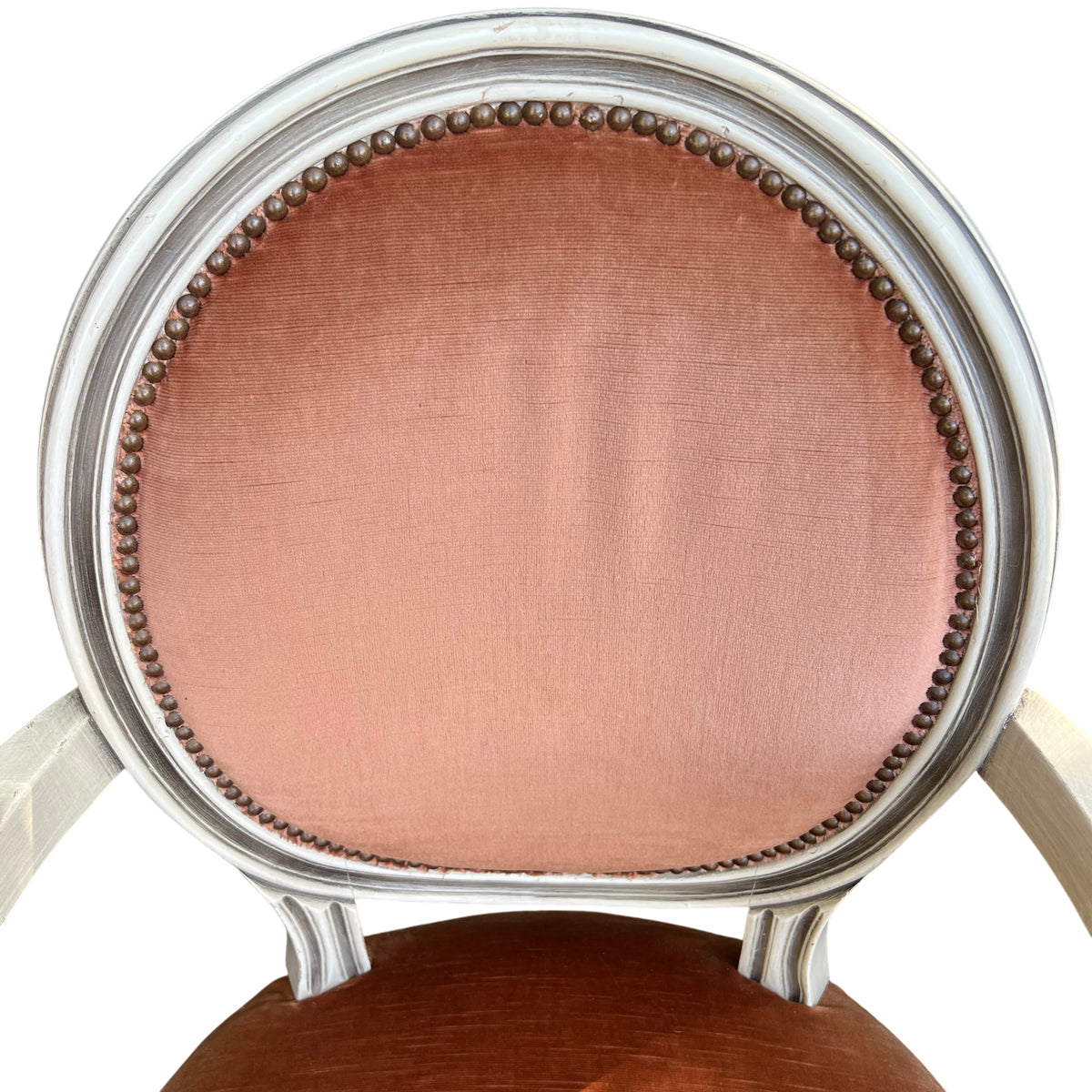 Detail of oval upholstered back with brass studs on a painted frame chair