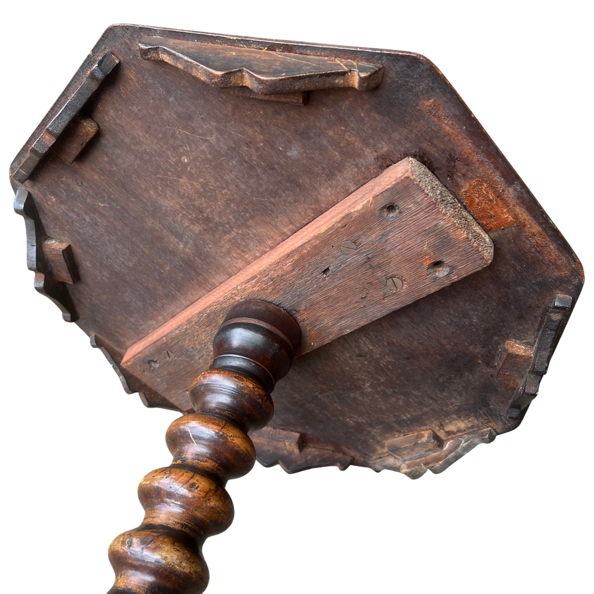 Base detail of carved tripod legs and underside of column on a small walnut table