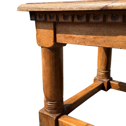 Top-down view of oak coffee table top with visible water stain and marks