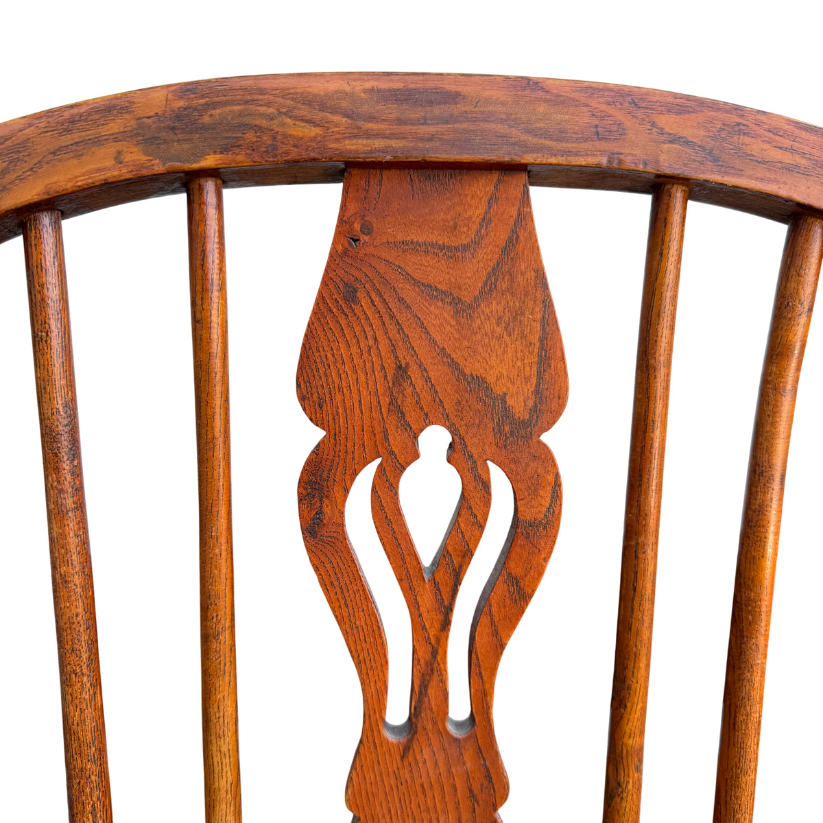 Low seat vintage Windsor-style armchair showing shaped seat and spindle back