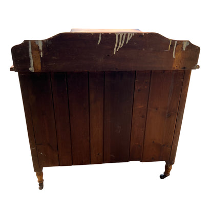 Side view showing the shaped gallery top and top surface of the pine chest