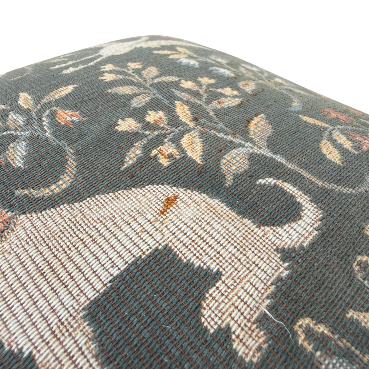 Underside edge and studded trim detail on small vintage footstool