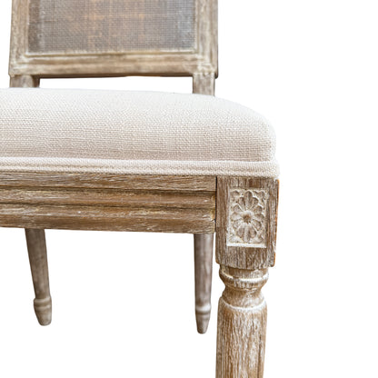 Cream upholstered dining chair seat with piped edge and textured fabric