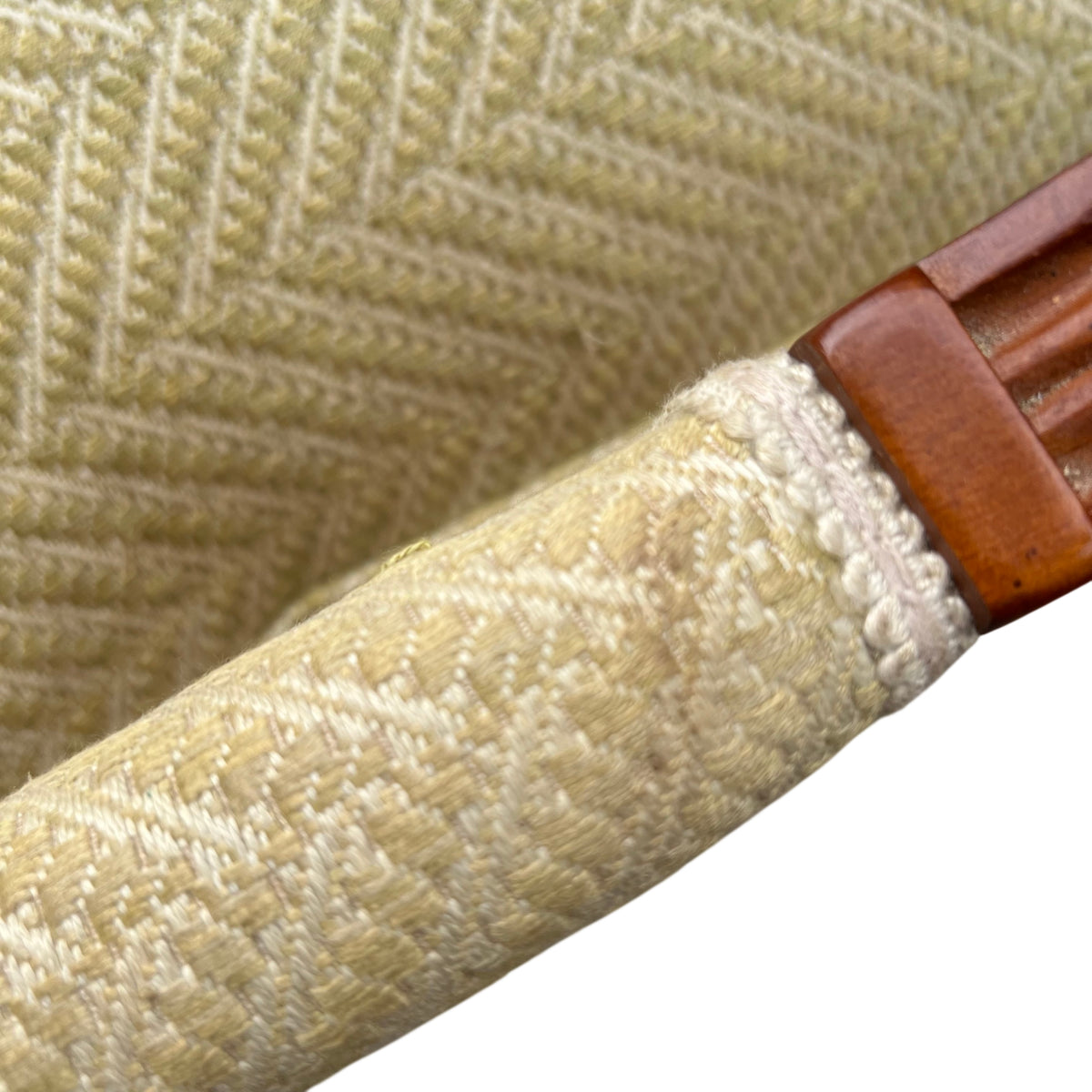 Lowered leg visible on wooden estate-style cane armchair