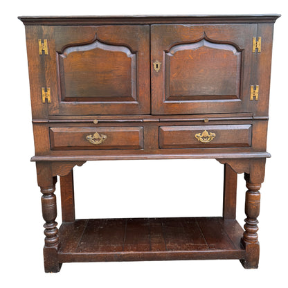 Compact oak cabinet on stand with two drawers and lower shelf