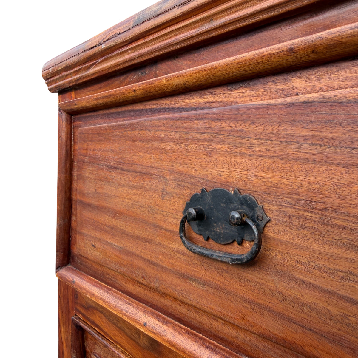Lower drawers and plinth base of rustic solid wood chest with visible surface wear