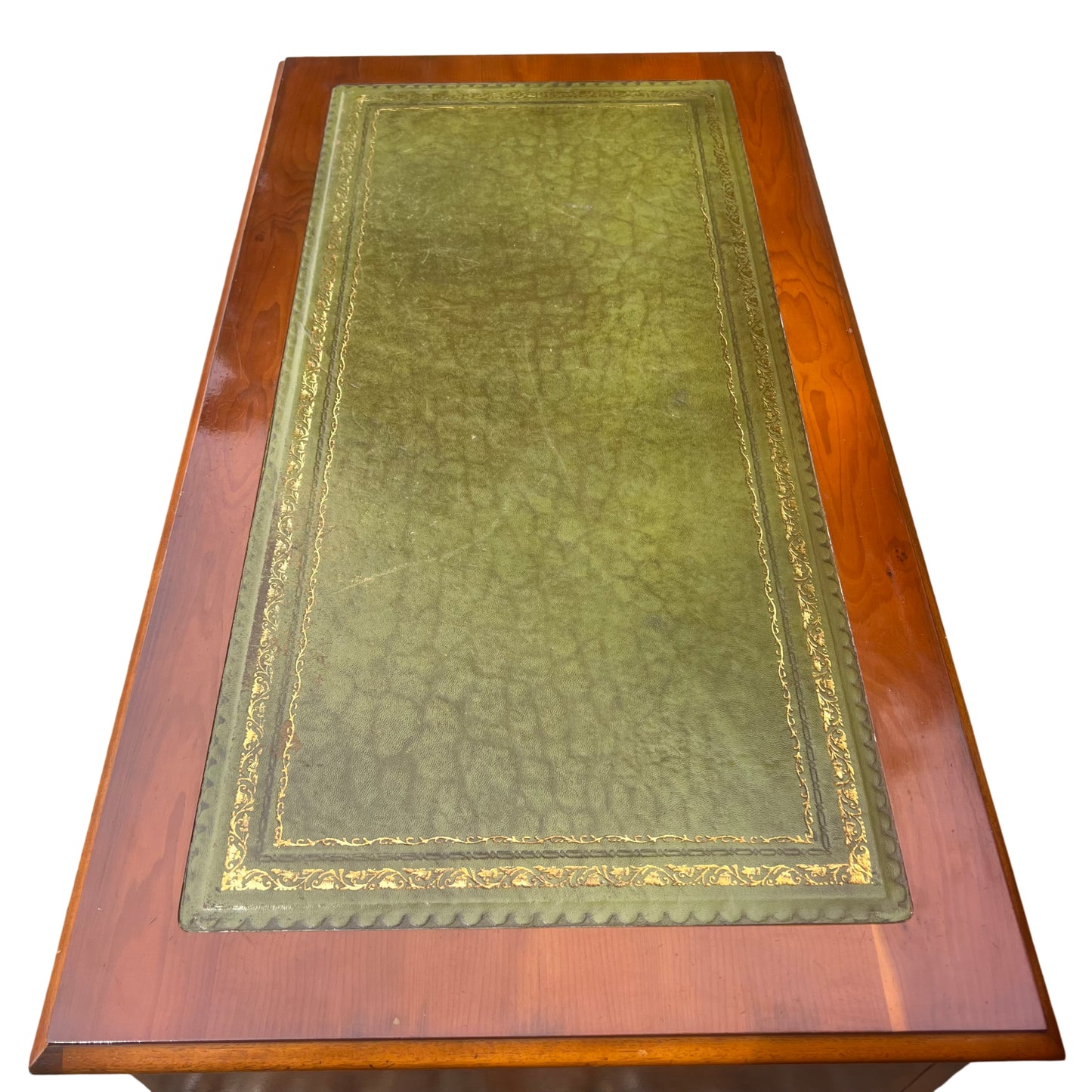 Top edge of wooden desk showing inset leather and small edge chips