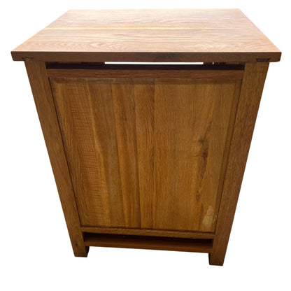 Side view of oak display cabinet showing paneled construction and legs