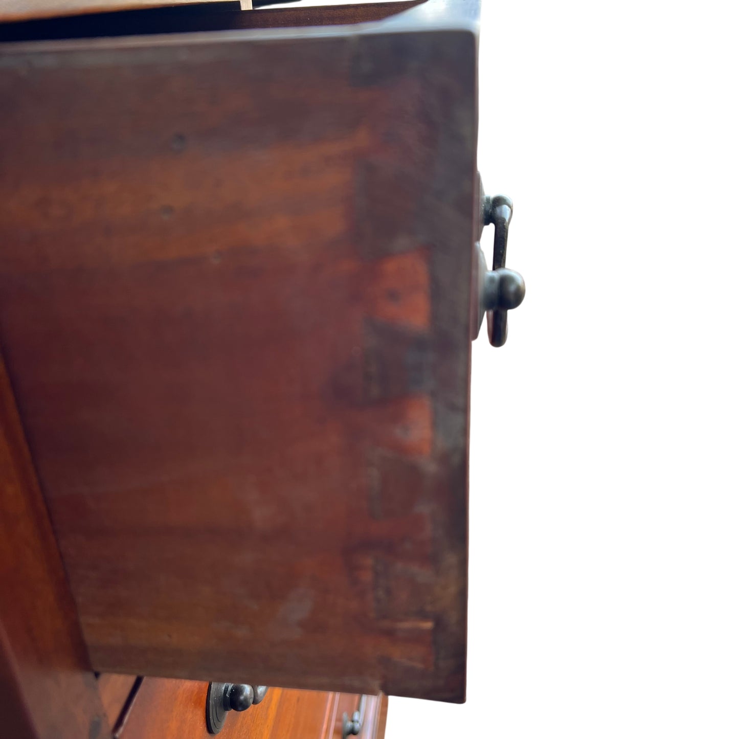 Side panel detail of tall chest showing raised fielded panel and moulded edges
