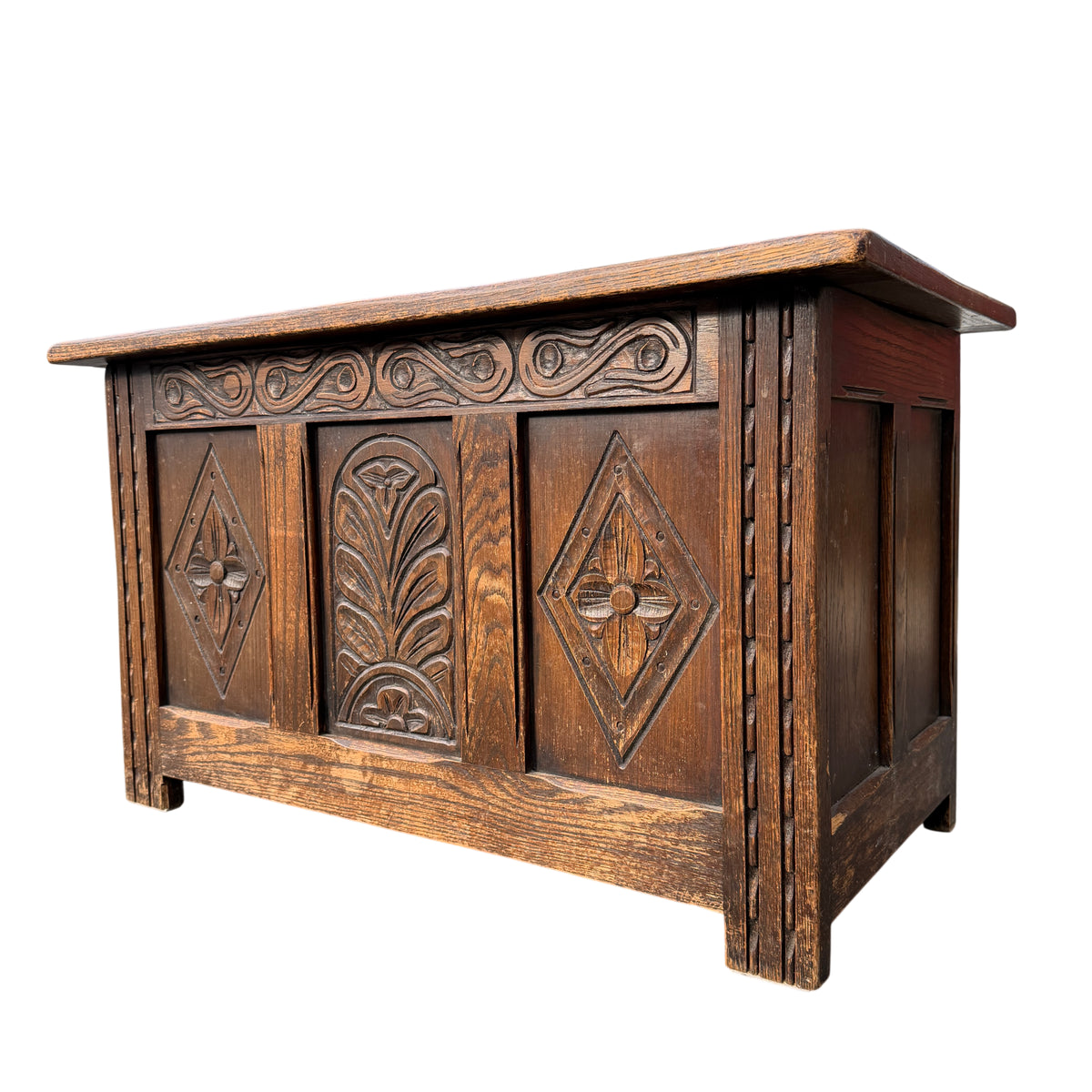 Bevan Funnell carved oak blanket chest with carved front panels and fitted boarded top