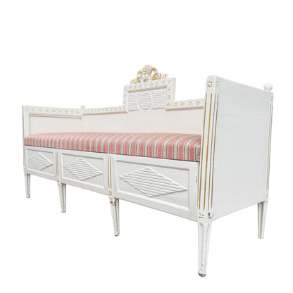 Striped removable cushion on vintage French-style painted daybed