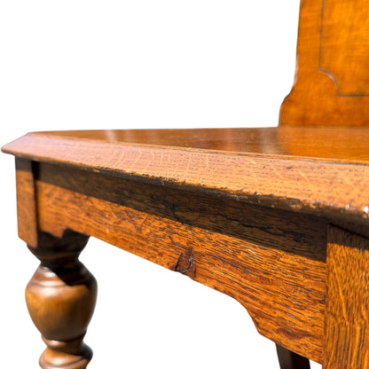 Detail of turned front leg on Victorian oak chair with tapered foot