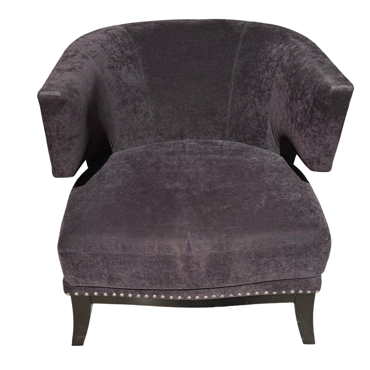 Close up of studded trim along arm and base of dark upholstered armchair