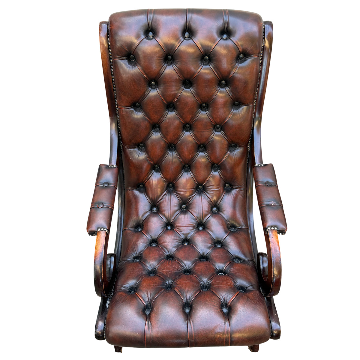 Top section close-up of button-tufted brown leather armchair backrest