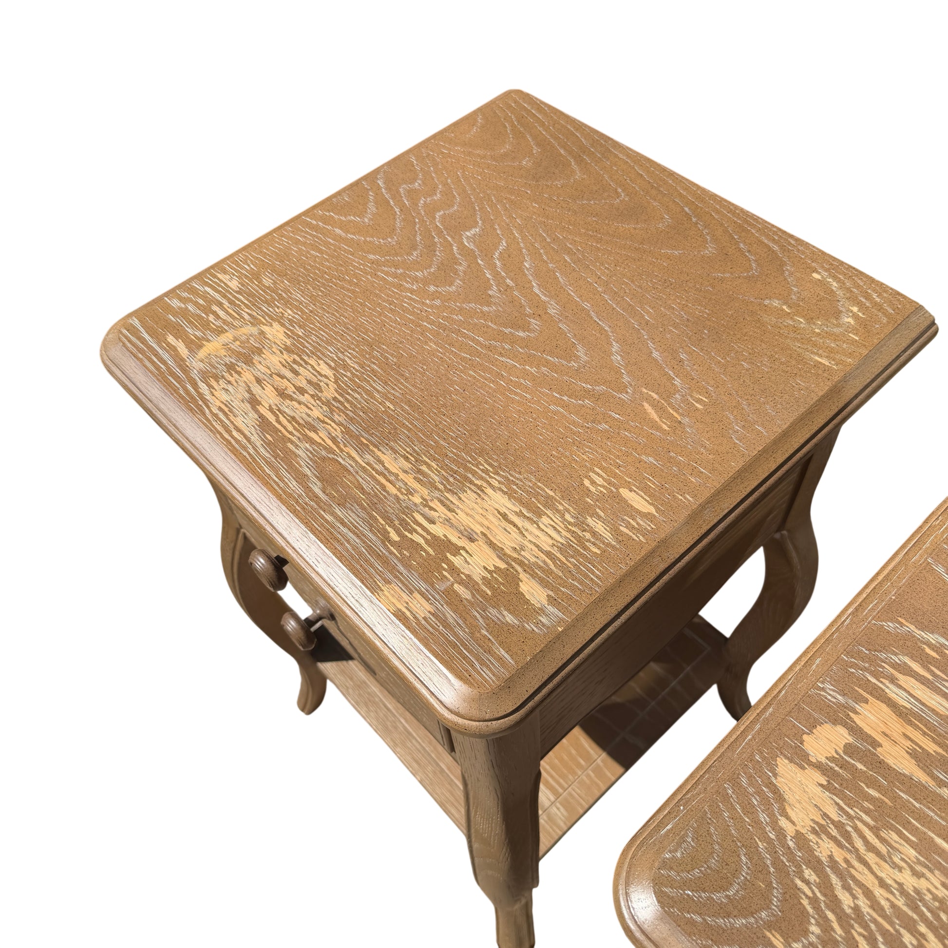 Top surfaces of bedside cabinets showing oak grain and painted finish