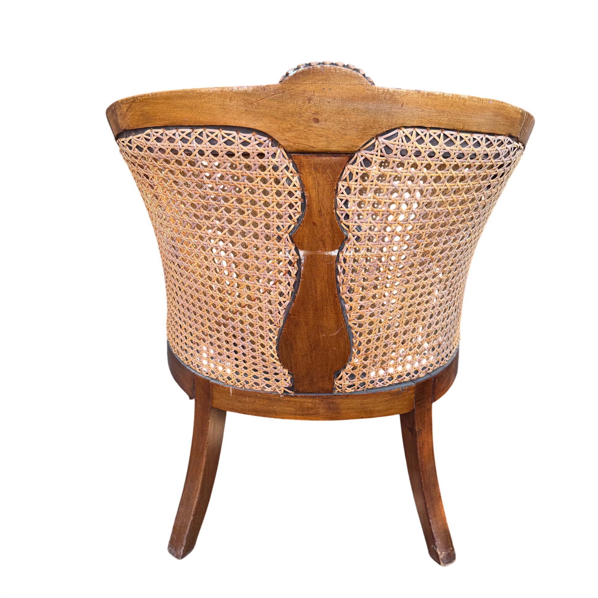 Three-quarter view of carved wooden armchair with cane back and sides