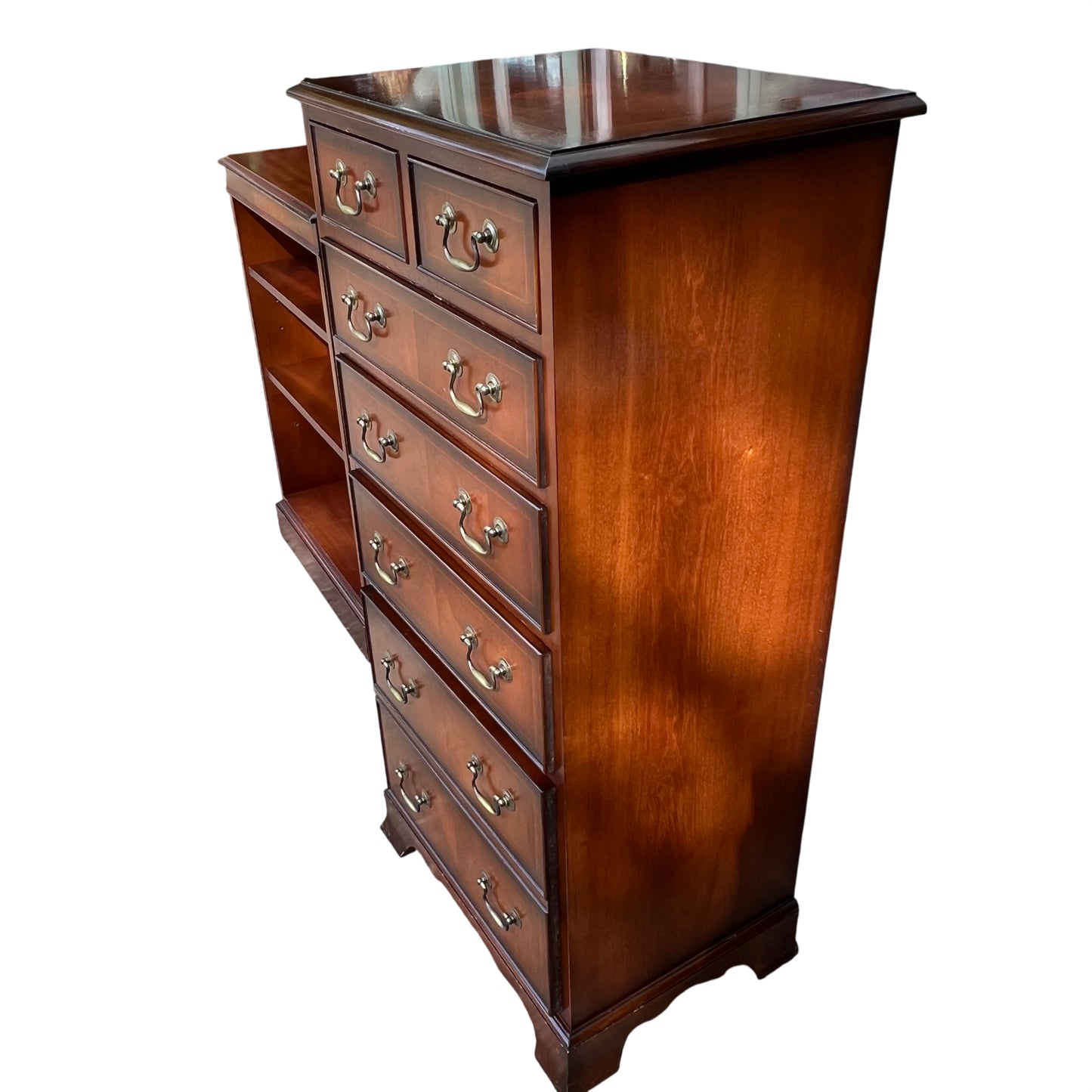 Side view of narrow tall mahogany chest of drawers showing moulded top