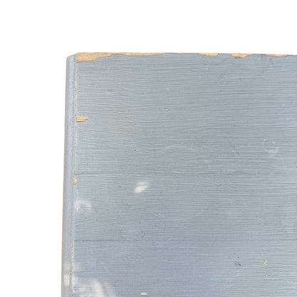 Top-down view of painted pine chest edge showing chip to paint and surface wear