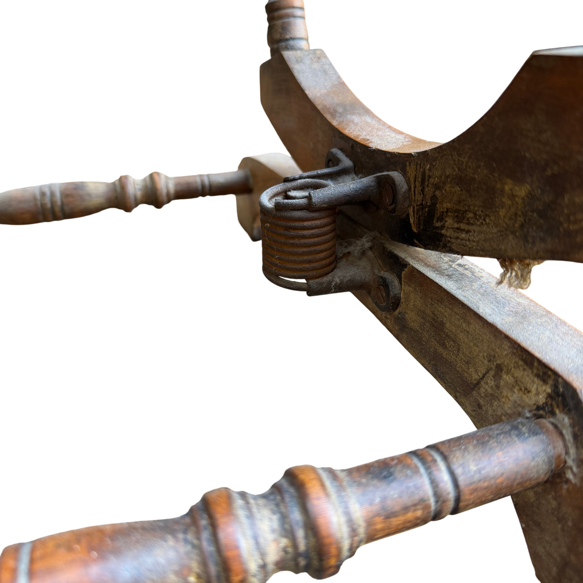 Side view of vintage child's rocking chair showing turned arm and spindle detail