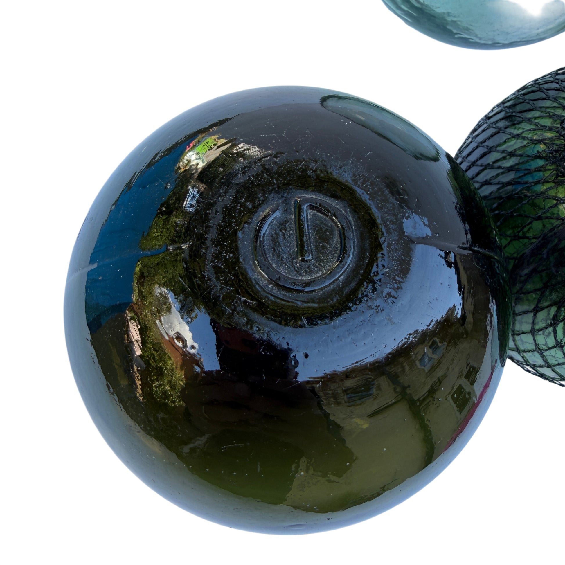 Dark olive vintage glass fishing float showing mould seam and pontil scar