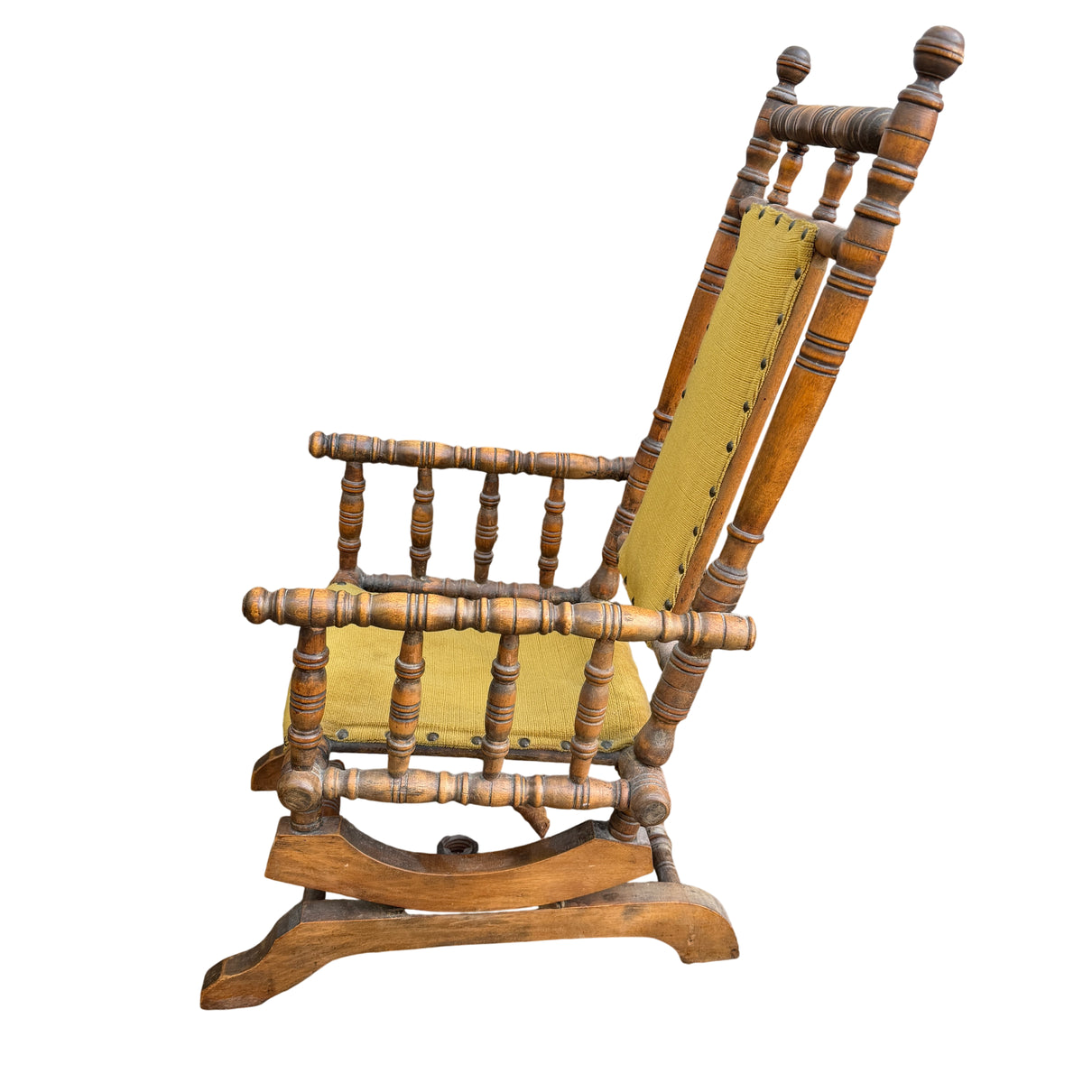 Small children's rocking chair with turned spindle wooden frame and worn finish