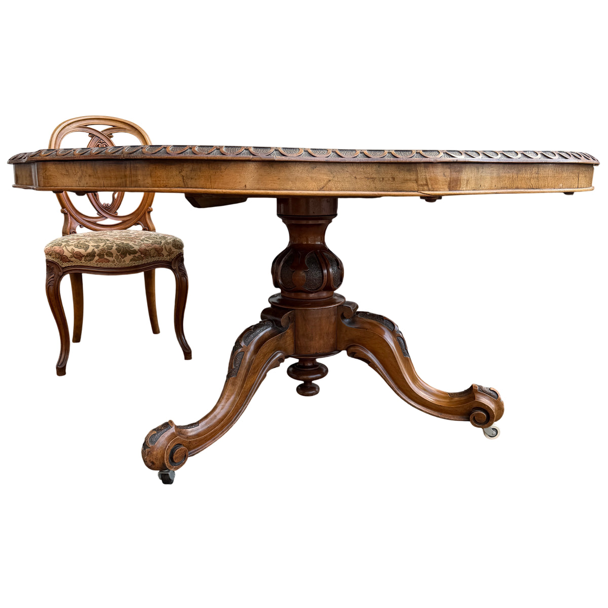 Arrangement of four Victorian style chairs around burl walnut dining table outdoors