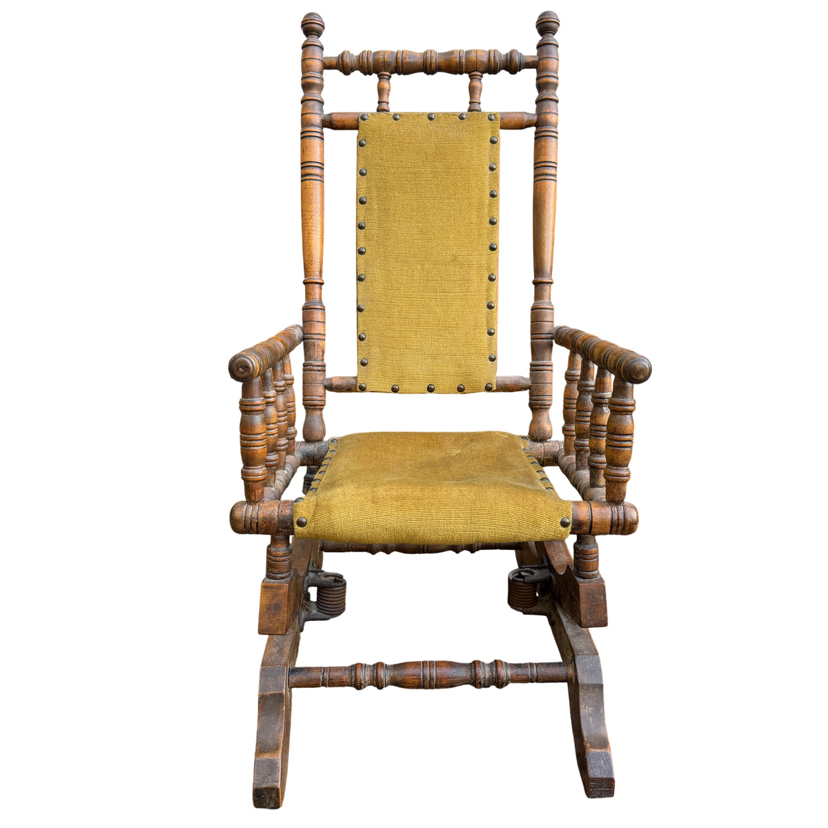 Turned spindle legs and stretchers on a small wooden rocking chair