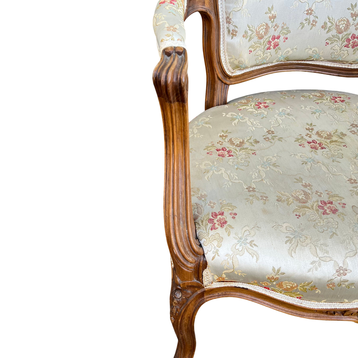 Detail of arm pad and carved walnut arm on a French-style bergère armchair