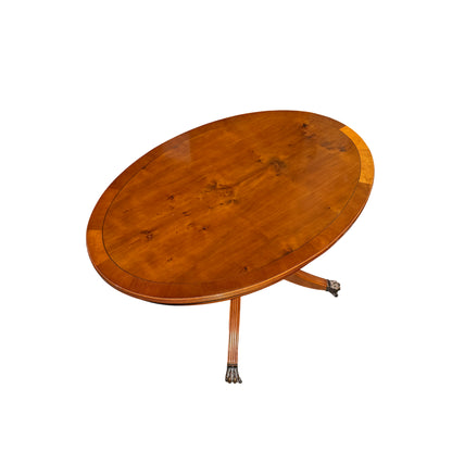 Top down view of oval dining table showing matched wood grain and finish