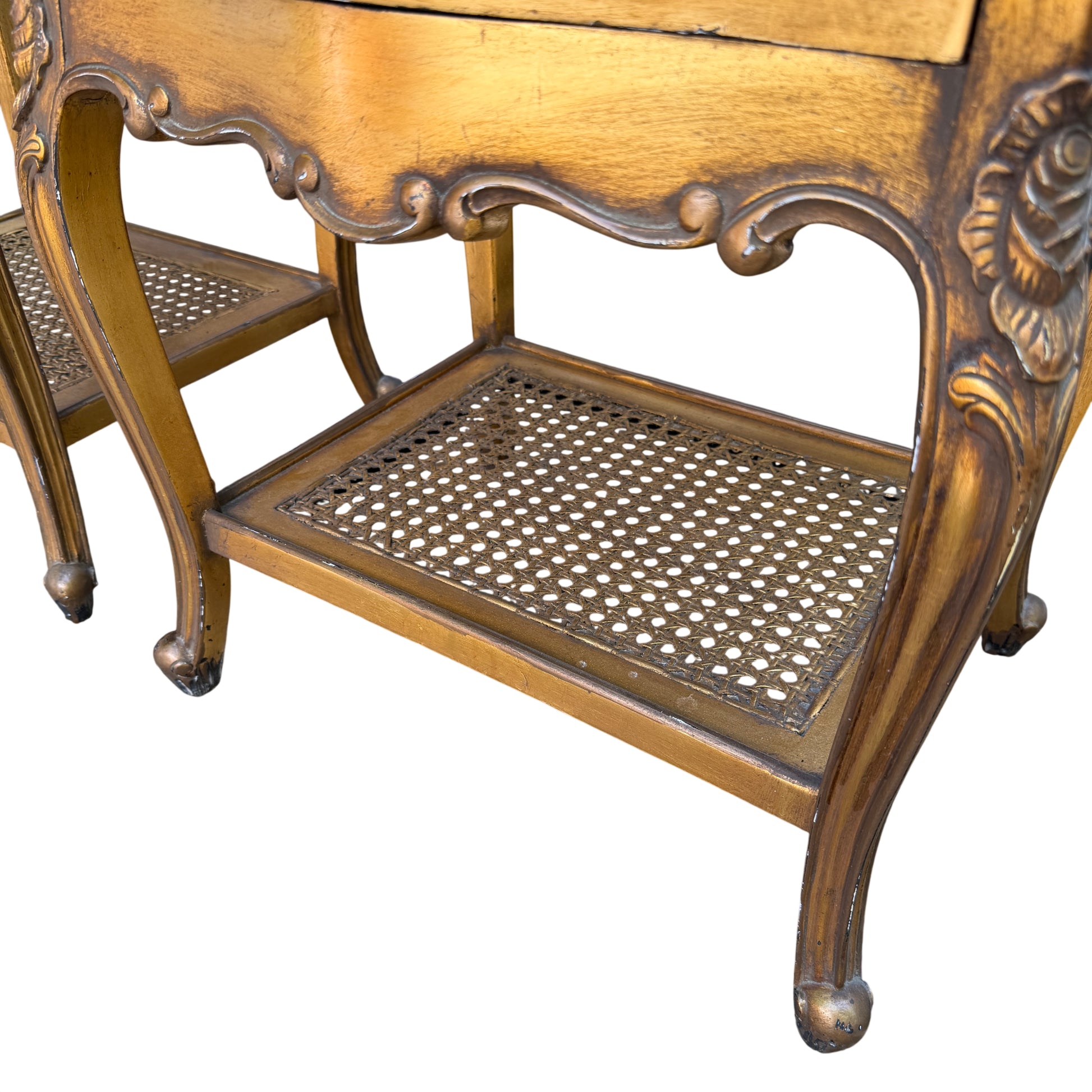Detail of carved apron and leg on a gold painted bedside cabinet