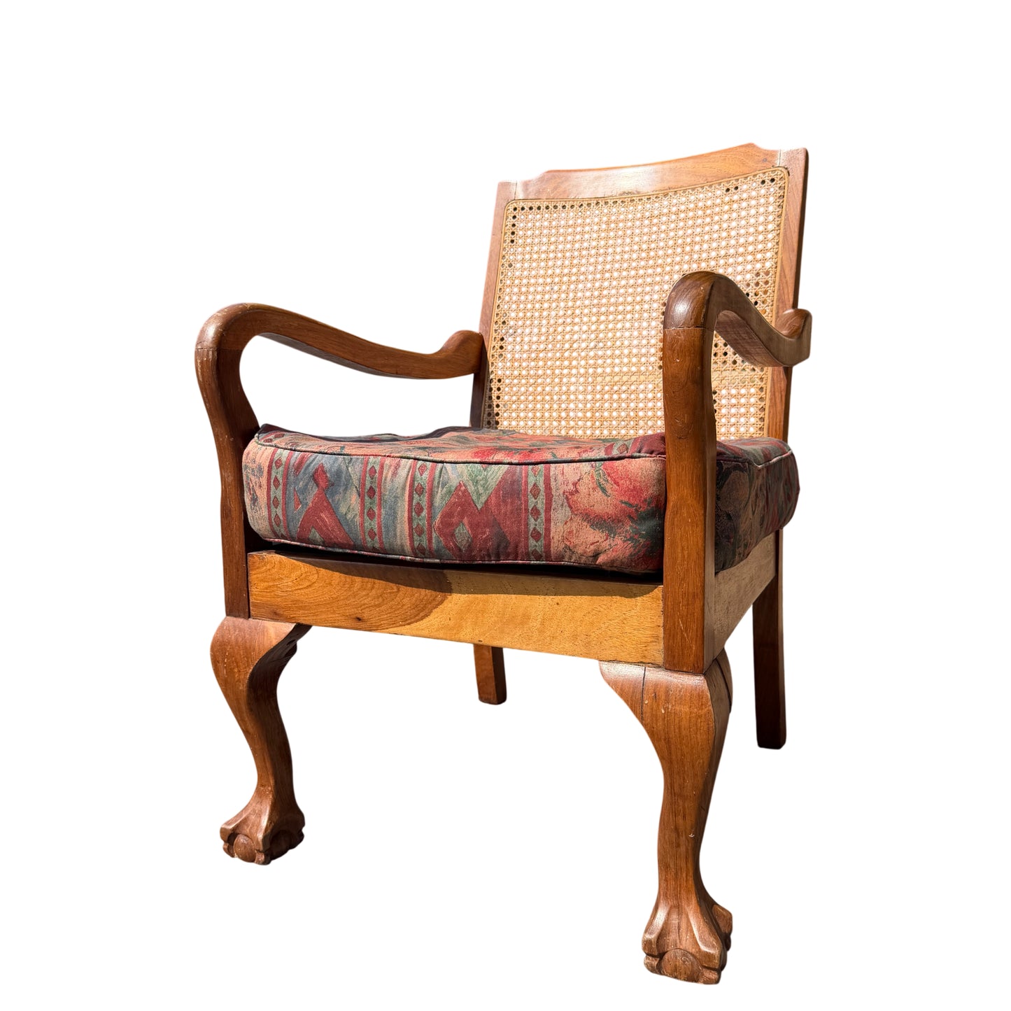 Front view of vintage cane back armchair with upholstered cushion