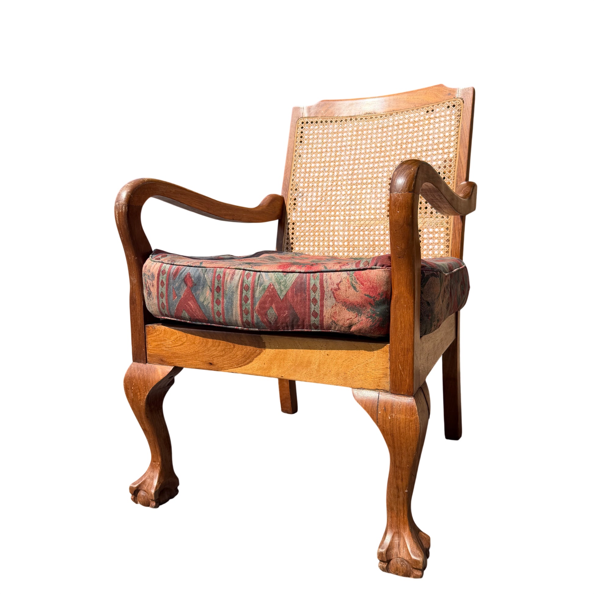 Front view of vintage cane back armchair with upholstered cushion